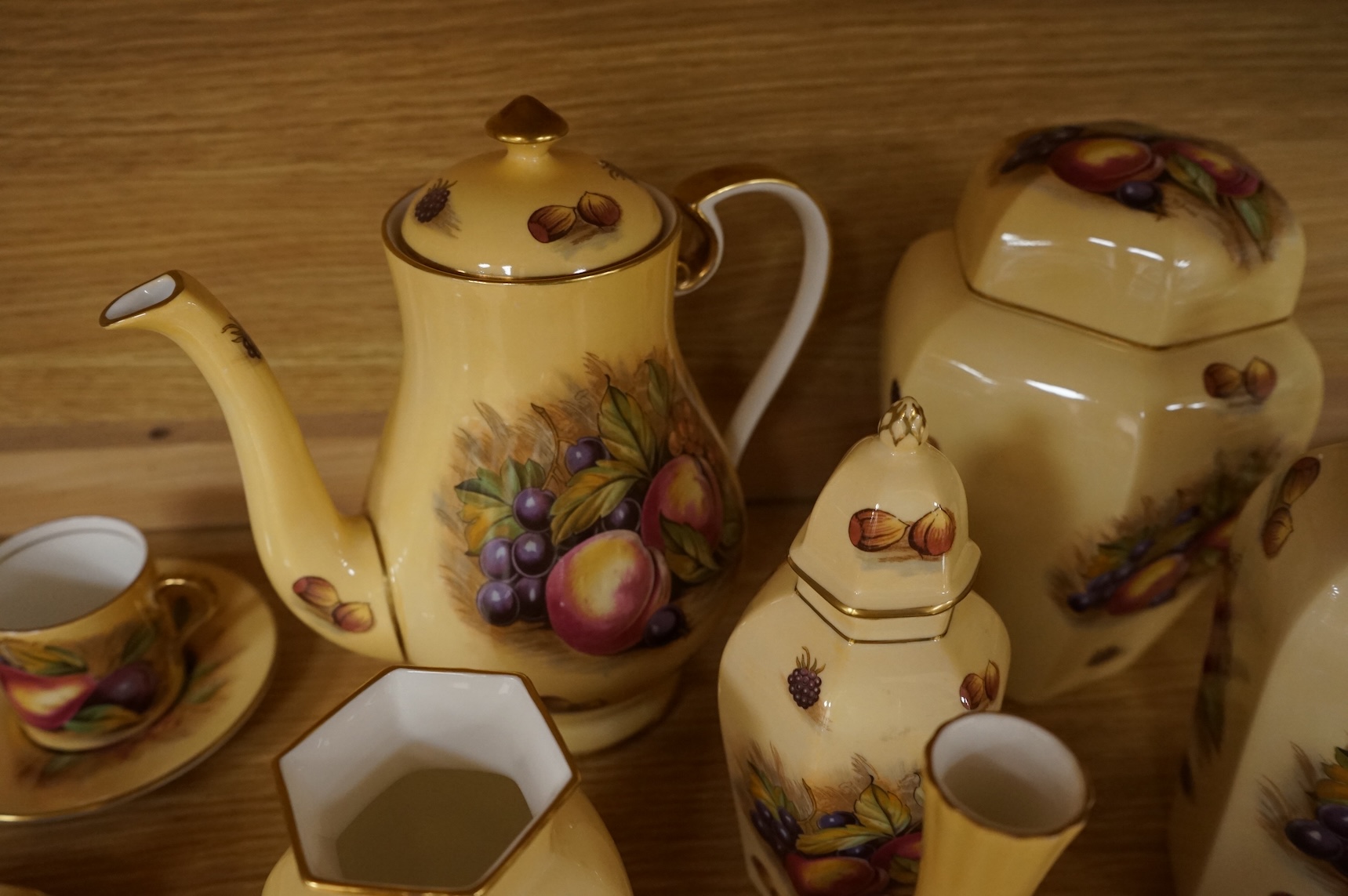 A collection of Aynsley ‘Orchard Gold’ fruit-painted tea/dinner wares and vases, largely signed by D Jones, largest 26cm in diameter